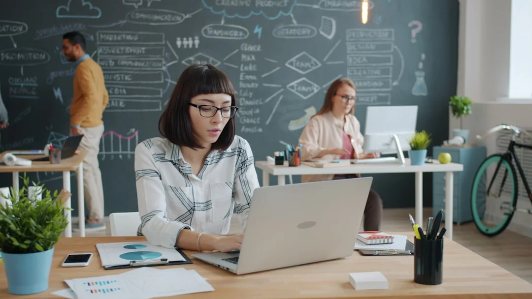 Stylish and efficient workspace with multiple monitors, laptop, and smartphone, showcasing a web design project.